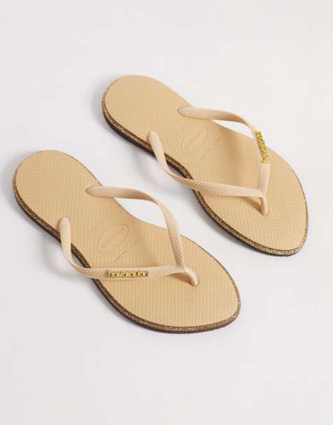 Havaianas – Guldfärgade, glittriga, smala flip flops - view 1