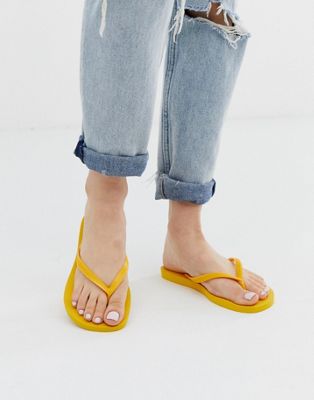 Havaianas slim flip flops in bright yellow | ASOS