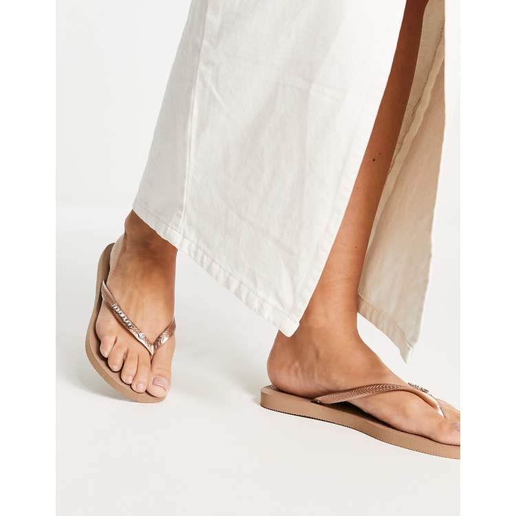 https://images.asos-media.com/products/havaianas-slim-flip-flops-with-metal-logo-and-crystal-in-rose-gold/202676287-1-rosegold?$n_750w$&wid=750&hei=750&fit=crop