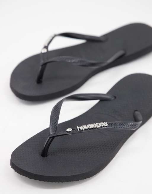 Havaianas - Slim klipklappere i sort med metallogo pog krystaller
