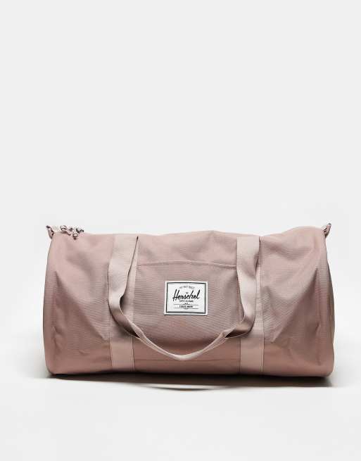 Pink herschel duffle bag on sale