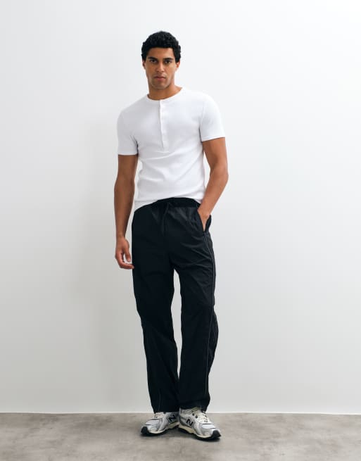 Hollister baggy side graphic track pants in black