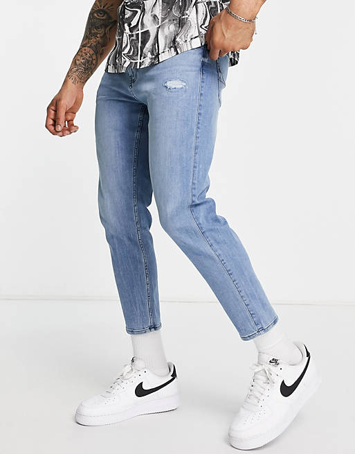 Hollister - Crop fit distressed jeans met toelopende pijpen en mid-wash