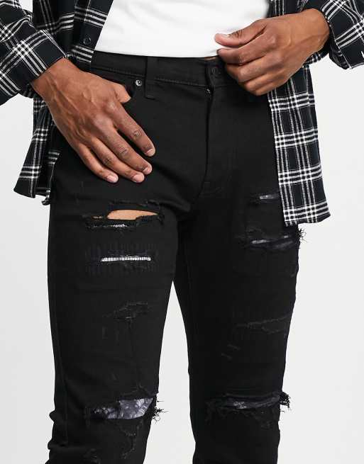 Hollister distressed and repair patch skinny fit jeans in black