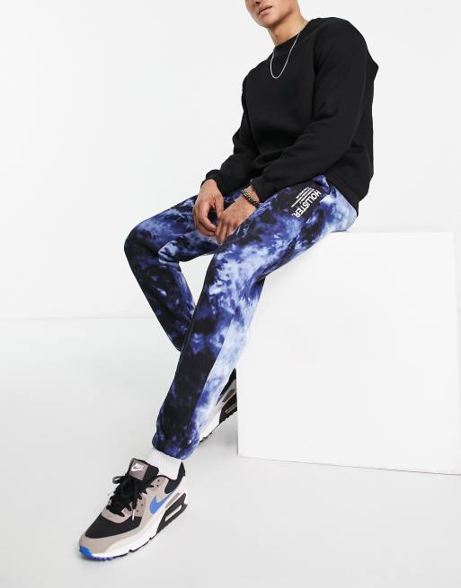 Hollister – Jogginghose aus Sweatstoff in Marineblau mit Acid-Waschung, seitlichem Logo und Bündchen