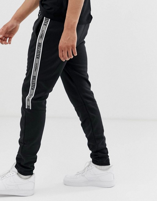 Hollister leg logo side piping cuffed joggers in black | ASOS