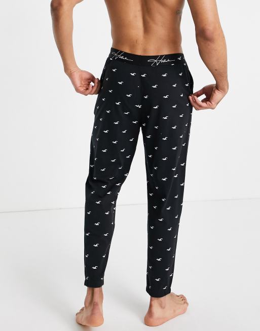 Hollister lounge sweatpants in black all over logo and logo waistband