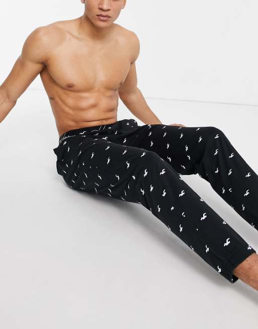 Hollister lounge sweatpants in black all over logo and logo waistband