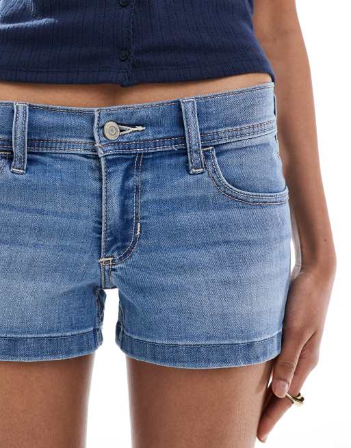 Hollister low rise split hem mini denim shorts in medium blue wash