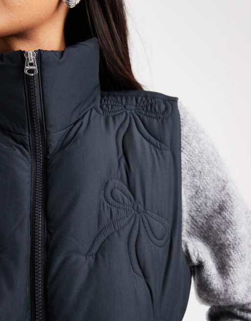 Hollister nylon puffer vest with bow pattern in black ASOS