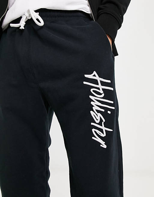 Hollister script logo sweatpants in black