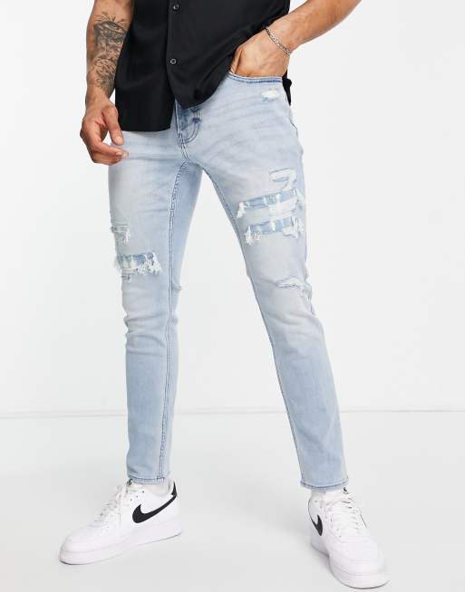 Hollister skinny fit distressed repair jeans in light wash | ASOS