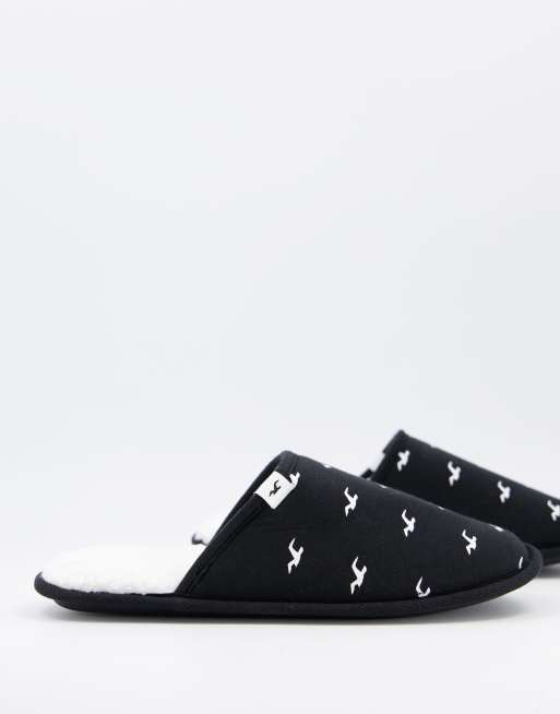 Hollister slipper in black with all over logo and fleece lining