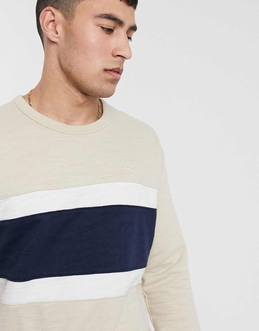 Hollister small logo crew neck sweatshirt chest panel stripe in light brown/navy