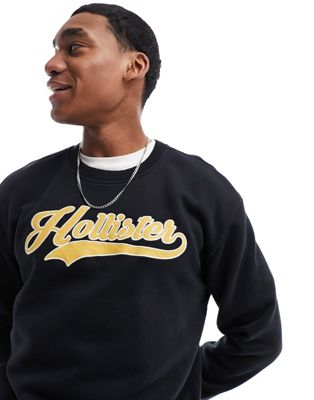 Hollister applique retro varsity logo relaxed fit sweatshirt in black - ASOS Price Checker