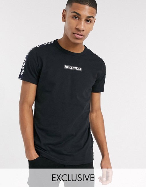 Hollister t-shirt in black with chest logo and sleeve taping exclusive to ASOS