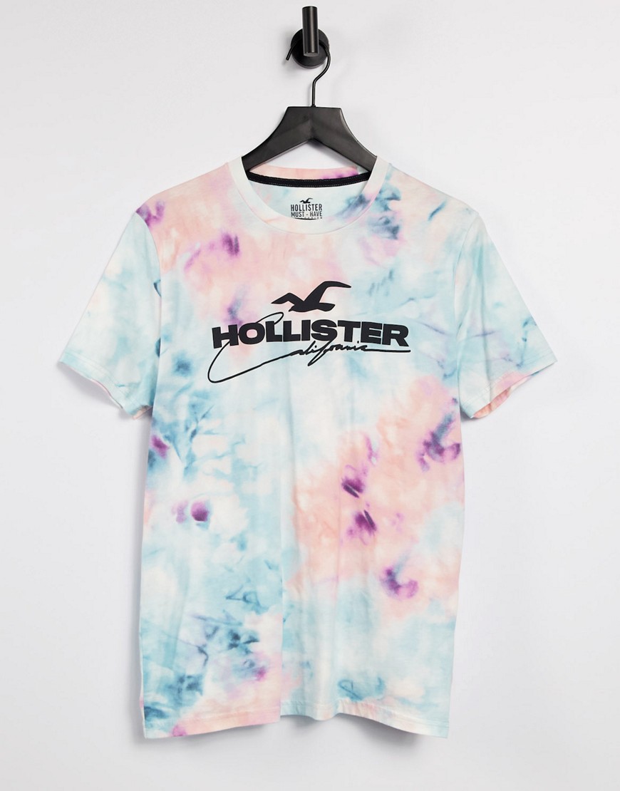 Hollister - T-shirt med logo foran i blå med multifarvet print overalt