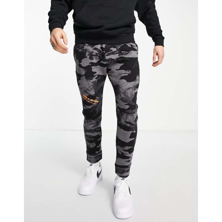 Hollister Print Logo Camo Print Skinny Joggers In Olive Green Camo, $32, Asos