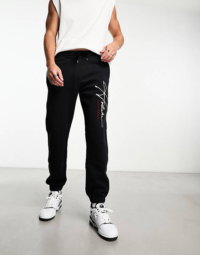 Hollister - tech leg logo relaxed fit cuffed joggers in black