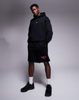 loose fit jersey shorts in black with pink logo - part of a set