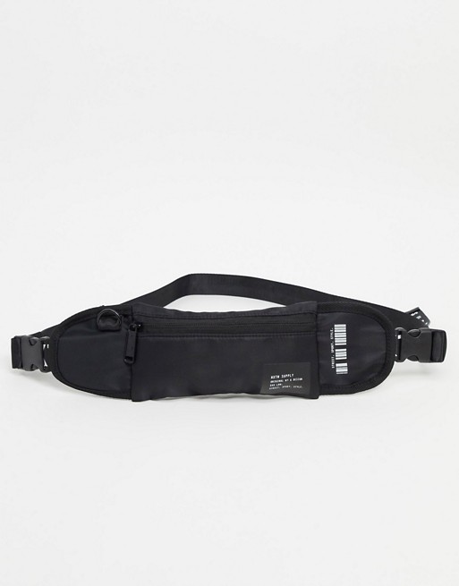 HXTN Supply slim crossbody bag in black with logo taping
