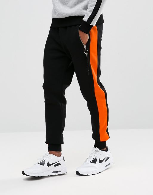 Black adidas best sale tracksuit orange stripes