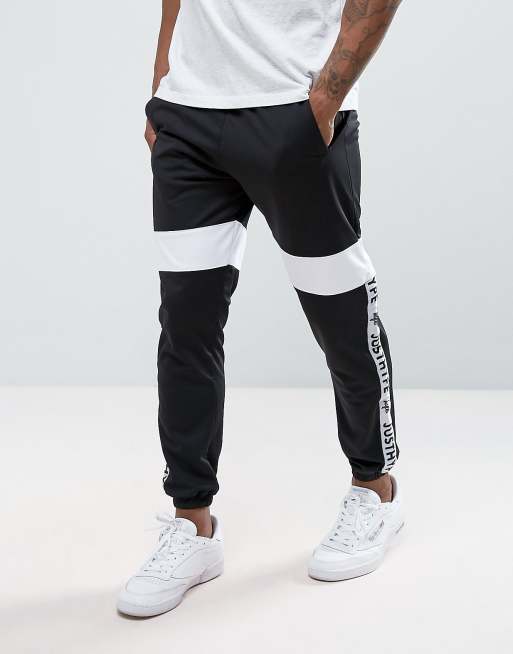 Nike taping skinny store fit joggers in black