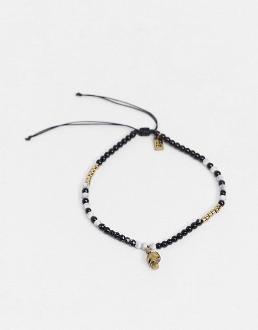Icon Brand beaded anklet in black and gold with skull charm