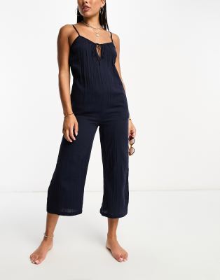 Iisla & Bird - Strand-Jumpsuit in Perlenschwarz mit weitem Bein und Riemchenträgern