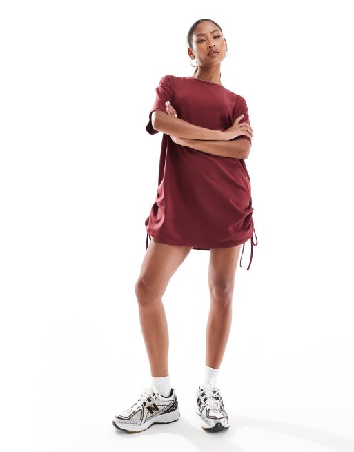 In The Style exclusive ruched side oversized mini t shirt dress in burgundy ASOS