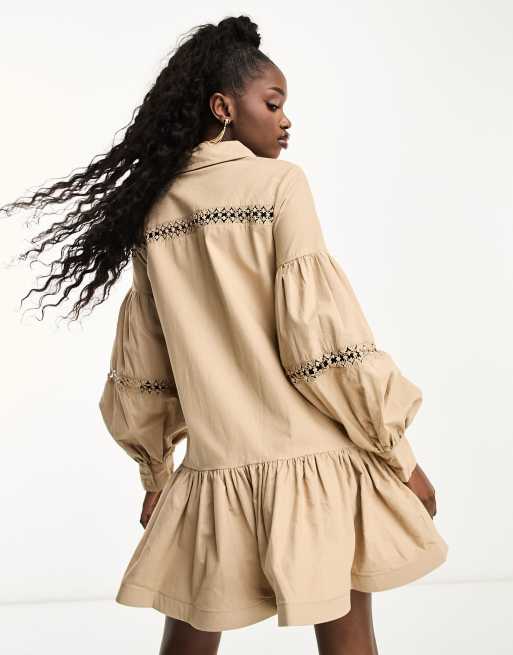 This Peplum Bell Sleeve Blouse with a ruffled hem takes Beige