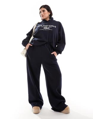 In The Style Plus x Perrie Sian exclusive wide leg jogger bottoms co-ord in navy - ASOS Price Checker