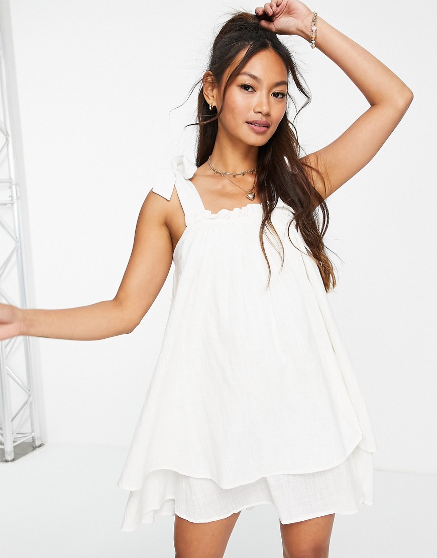 In The Style x Elle Darby tie shoulder trapeze layered mini dress in white