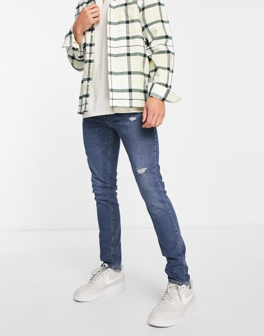Jack & Jones Intelligence Liam skinny fit jeans in super stretch with rip & repair in mid blue wash 