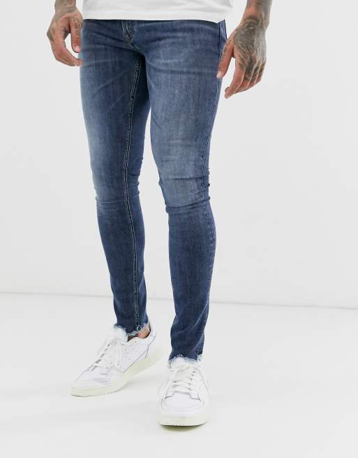 Jack & Jones Intelligence spray on fit raw hem jeans in mid wash | ASOS