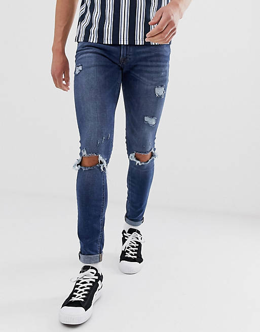 Jack & Jones Intelligence spray on skinny jeans with rip detail in mid blue