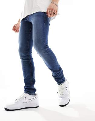 Jack & Jones liam skinny jeans in mid blue - ASOS Price Checker