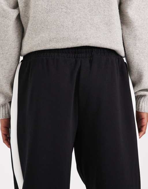 Jack Jones loose fit sweat pants in black with side stripe ASOS