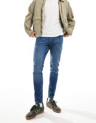 Jack & Jones Pete Slim Tapered Jeans In Mid Blue Wash