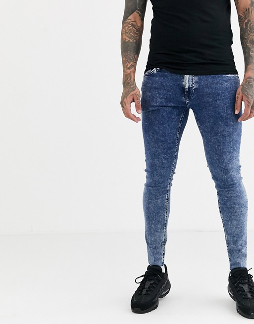 Jack & Jones Intelligence spray on skinny fit jeans with raw hem in blue acid wash