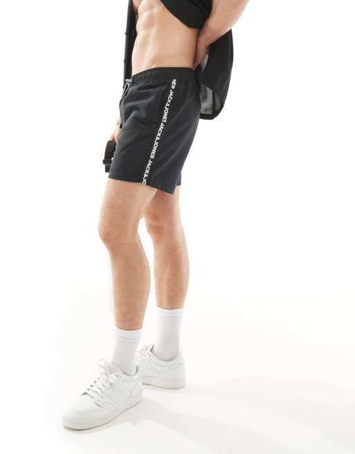 Jack & Jones swim shorts with logo trim in black 