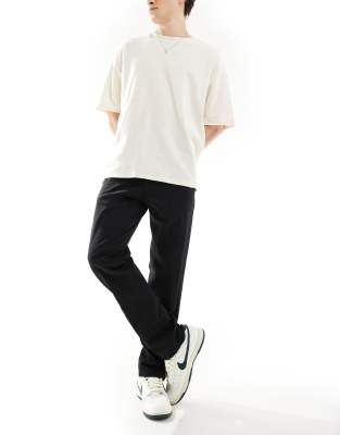 tapered pleat front chino pants in black