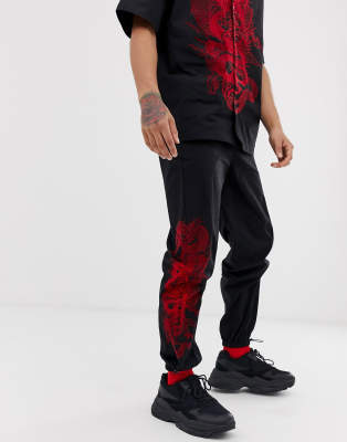 black sweatpants with red dragon