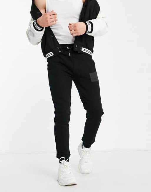 Jameson Carter leighton leather patch tapered joggers in black ASOS