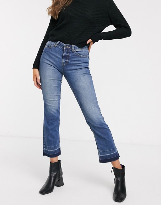 JDY kick flare cropped jeans with dropped hem in mid wash blue