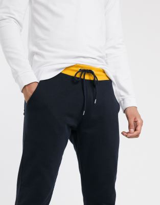 Joggers ajustados en azul marino con ribete amarillo de ASOS DESIGN | ASOS