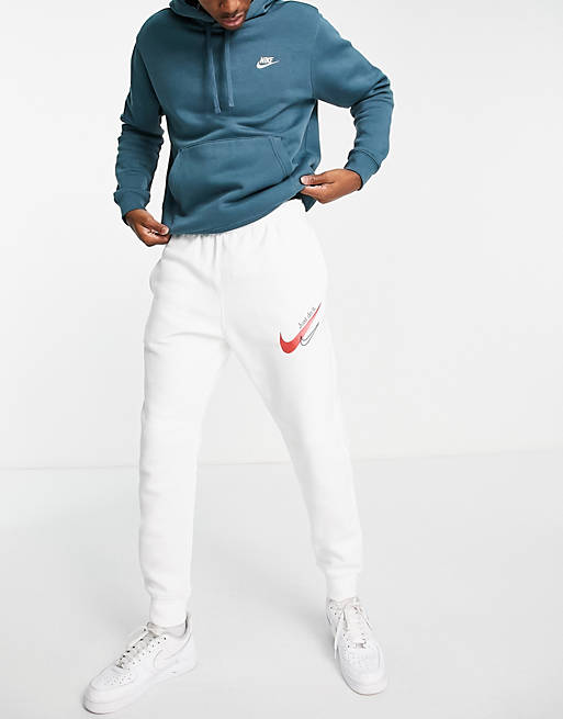 Hombre Joggers de ropa deportiva | Joggers blancos con logo rojo y bajos ajustados de Nike - YJ38649