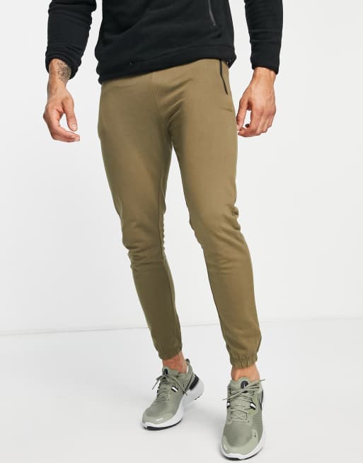 Joggers color oliva oscuro de corte slim con bolsillos de cremallera de Threadbare Active
