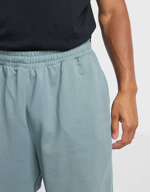 Joggers extragrandes azules grisáceos con alamares en el bajo de algodón orgánico de ASOS DESIGN, 3 de 4