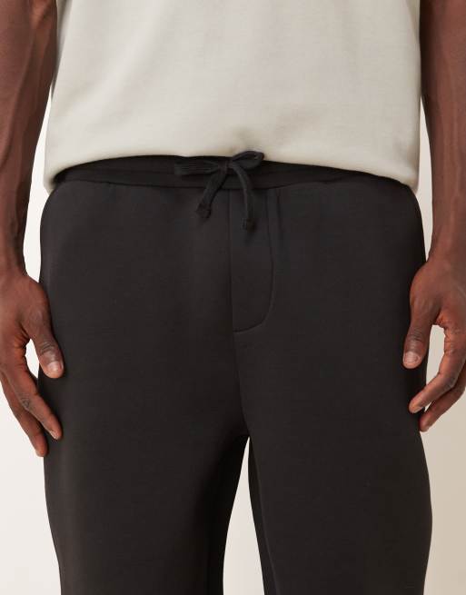 Joggers negros de corte tapered de tejido grueso efecto neopreno de ASOS DESIGN, 4 de 5